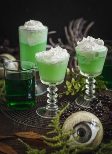 Harry Potter polyjuice potion in glasses topped with whipped cream.