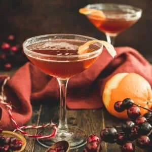 Pomegranate martini garnished with orange peel.