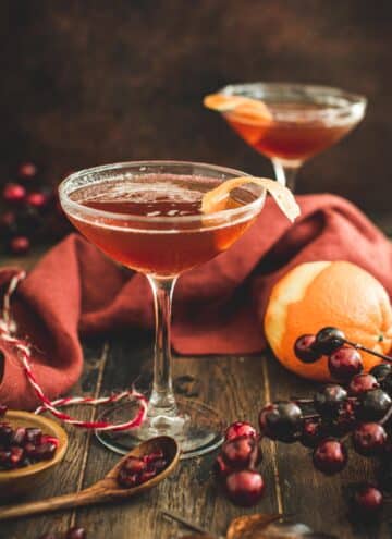 Pomegranate martini garnished with orange peel.