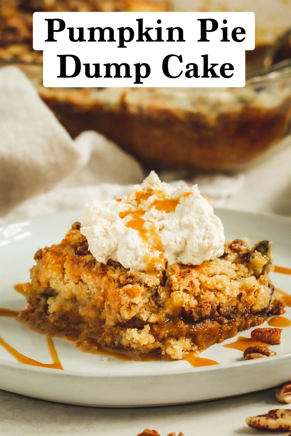 Pumpkin pie dump cake with whipped cream and caramel sauce on top.