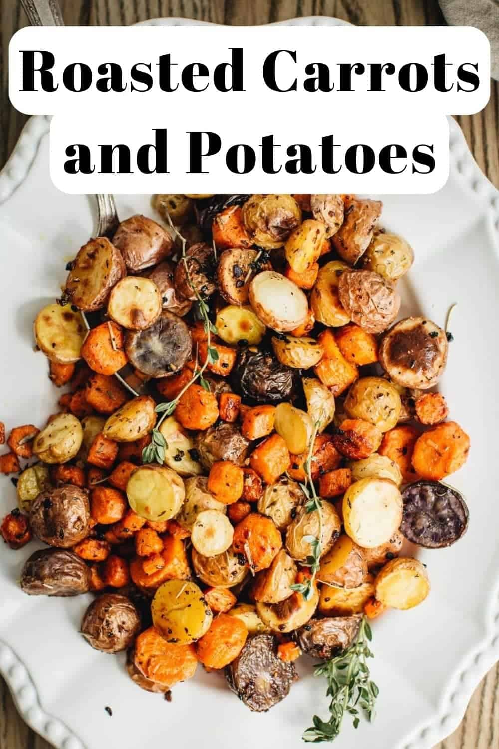 Roasted carrots and potatoes on a white platter.
