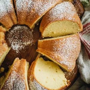 Sour cream pound cake sliced on a wooden board.