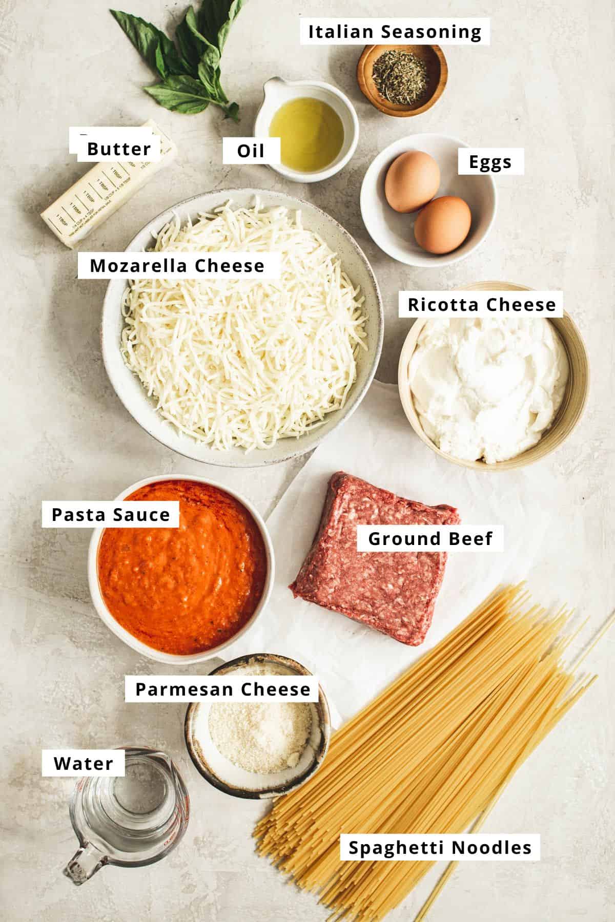 Spaghetti casserole ingredients in various bowls.