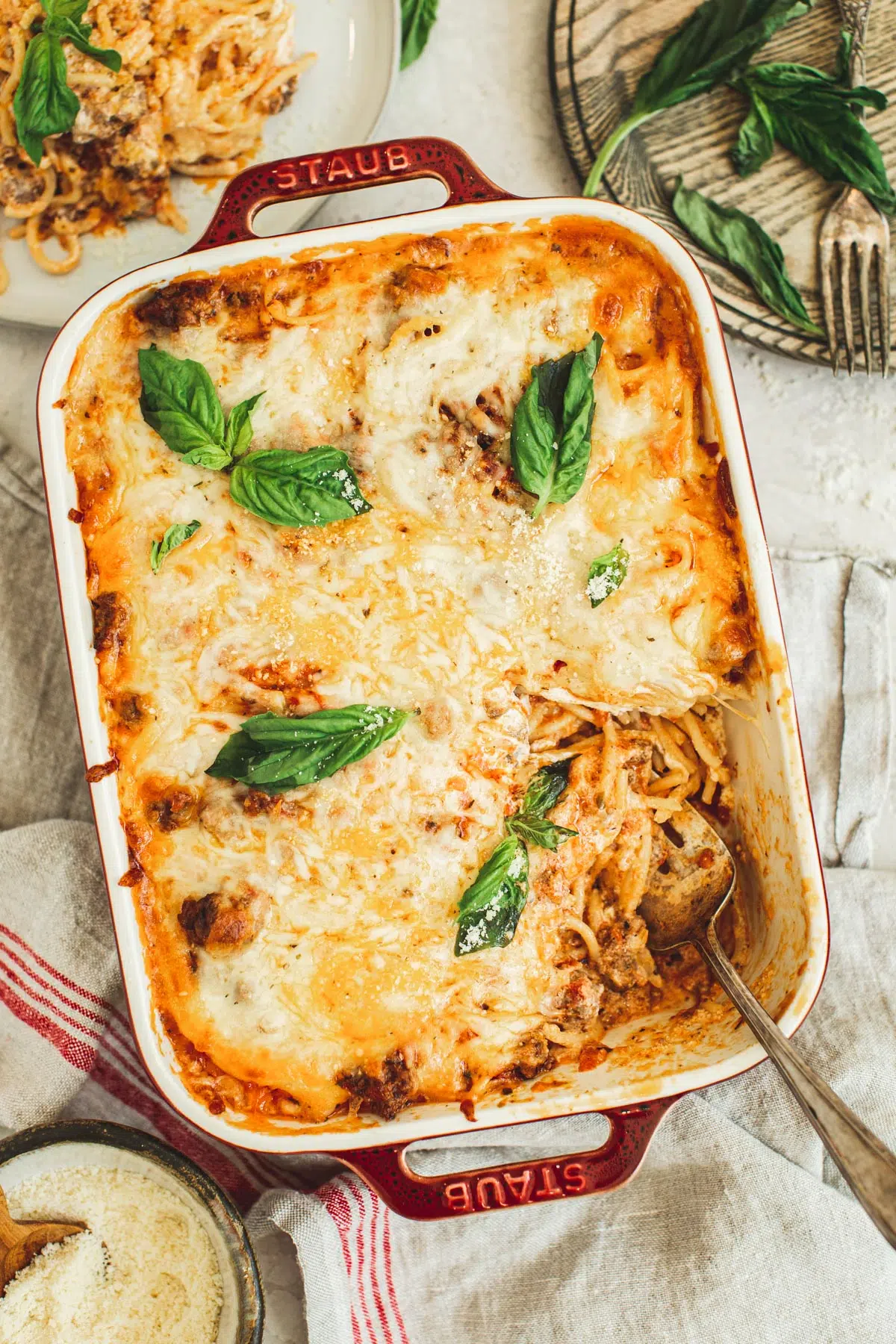 Spaghetti casserole in a red casserole dish.