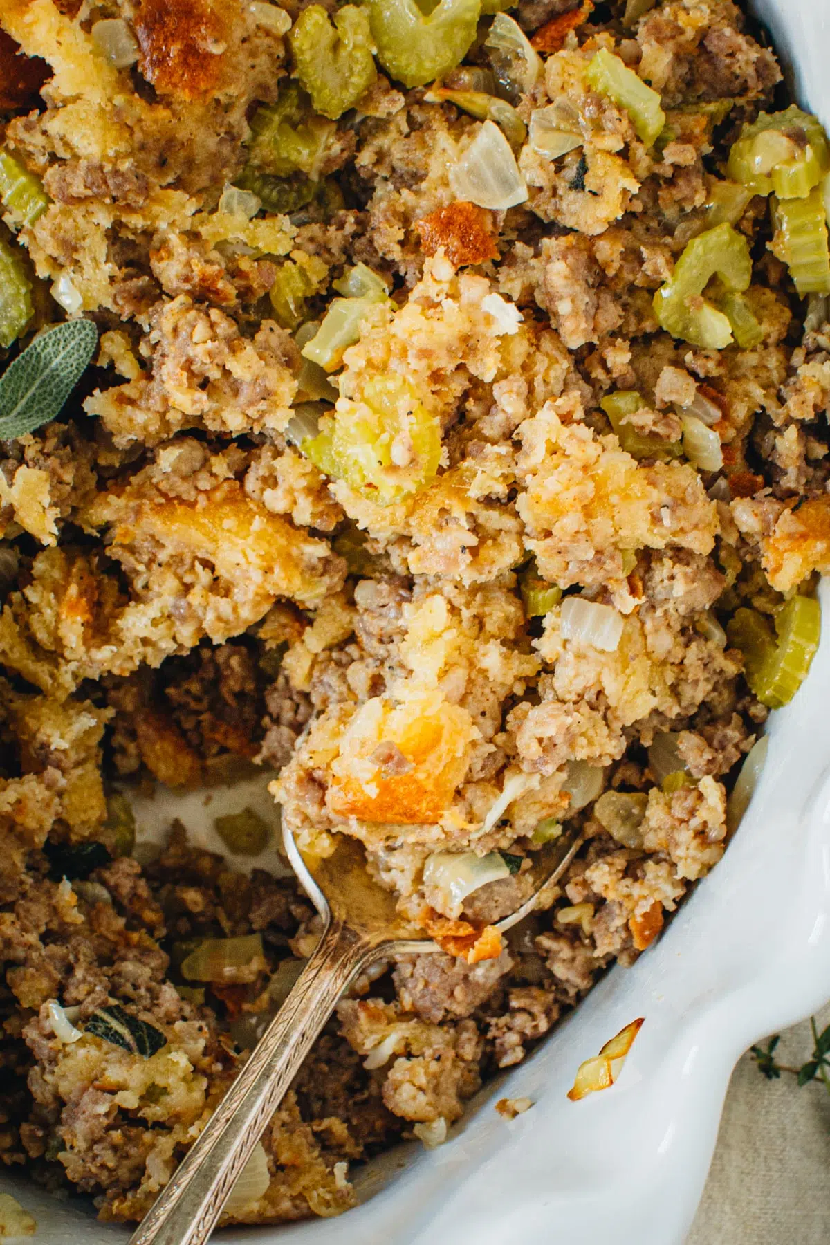 Stovetop stuffing in a white baking dish with a silver serving spoon.