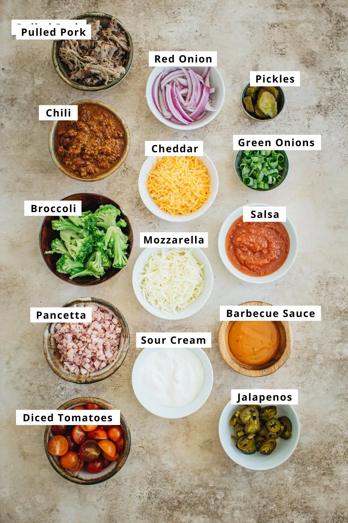 Baked potato bar toppings in various bowls.