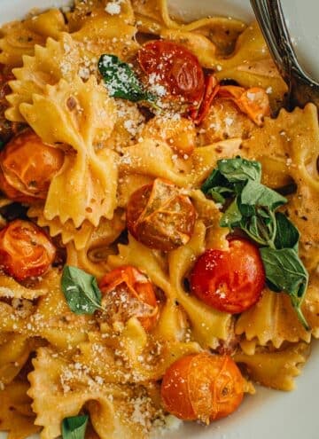 Creamy bow tie pasta topped with fresh parmesan and oregano.