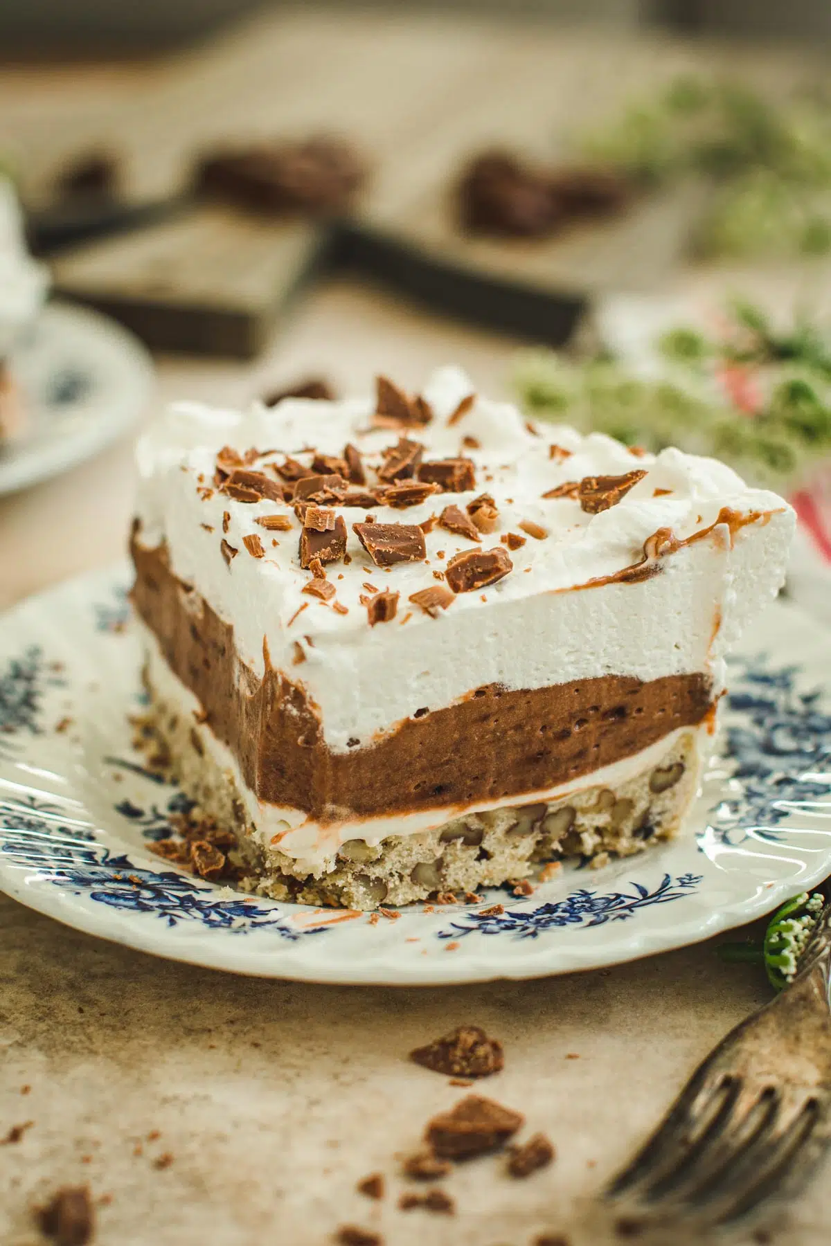 Slice of chocolate delight on a blue and white plate.