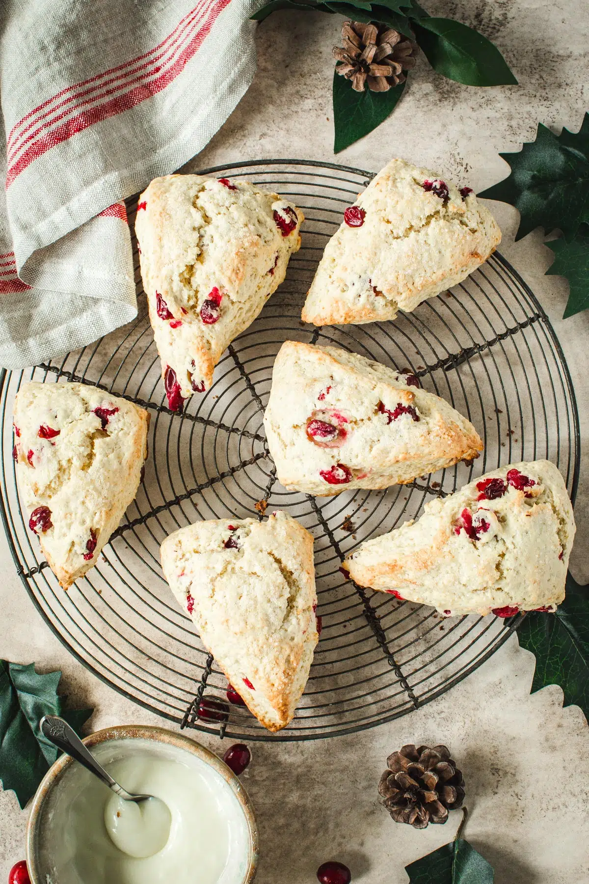 Cranberry orange scones on a round wire rack.