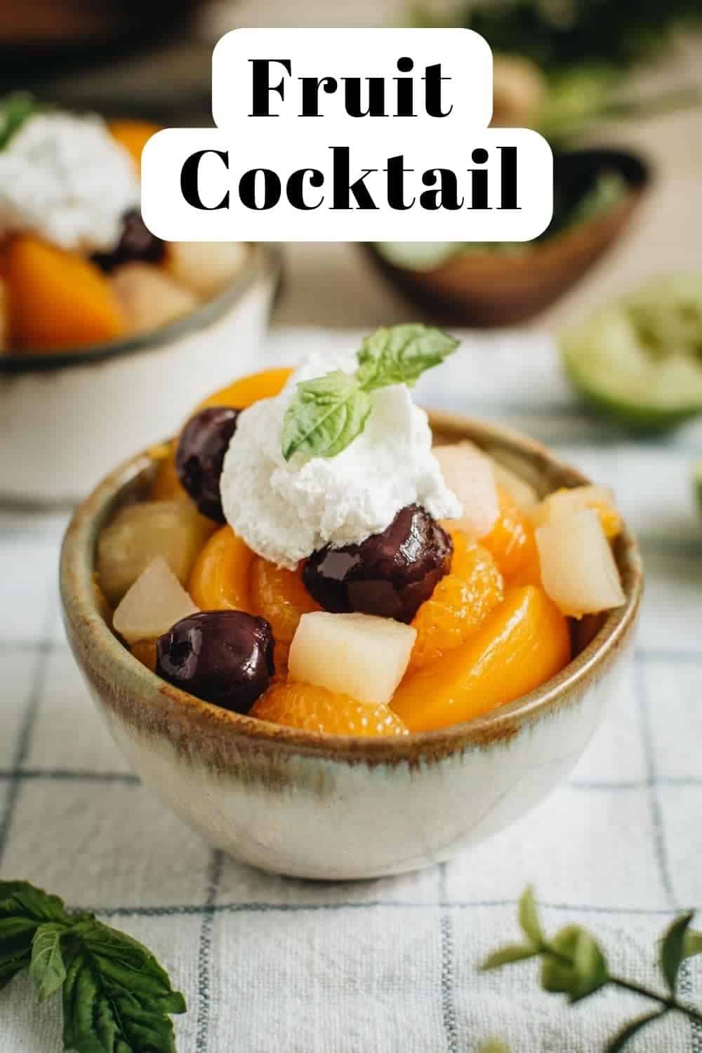 Easy fruit cocktail in a bowl topped with whipped cream.