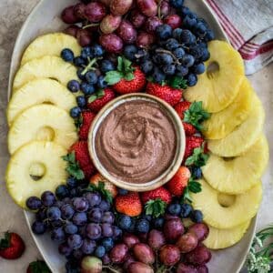 Easy fruit tray with fresh fruit and a chocolate fruit dip in the center.