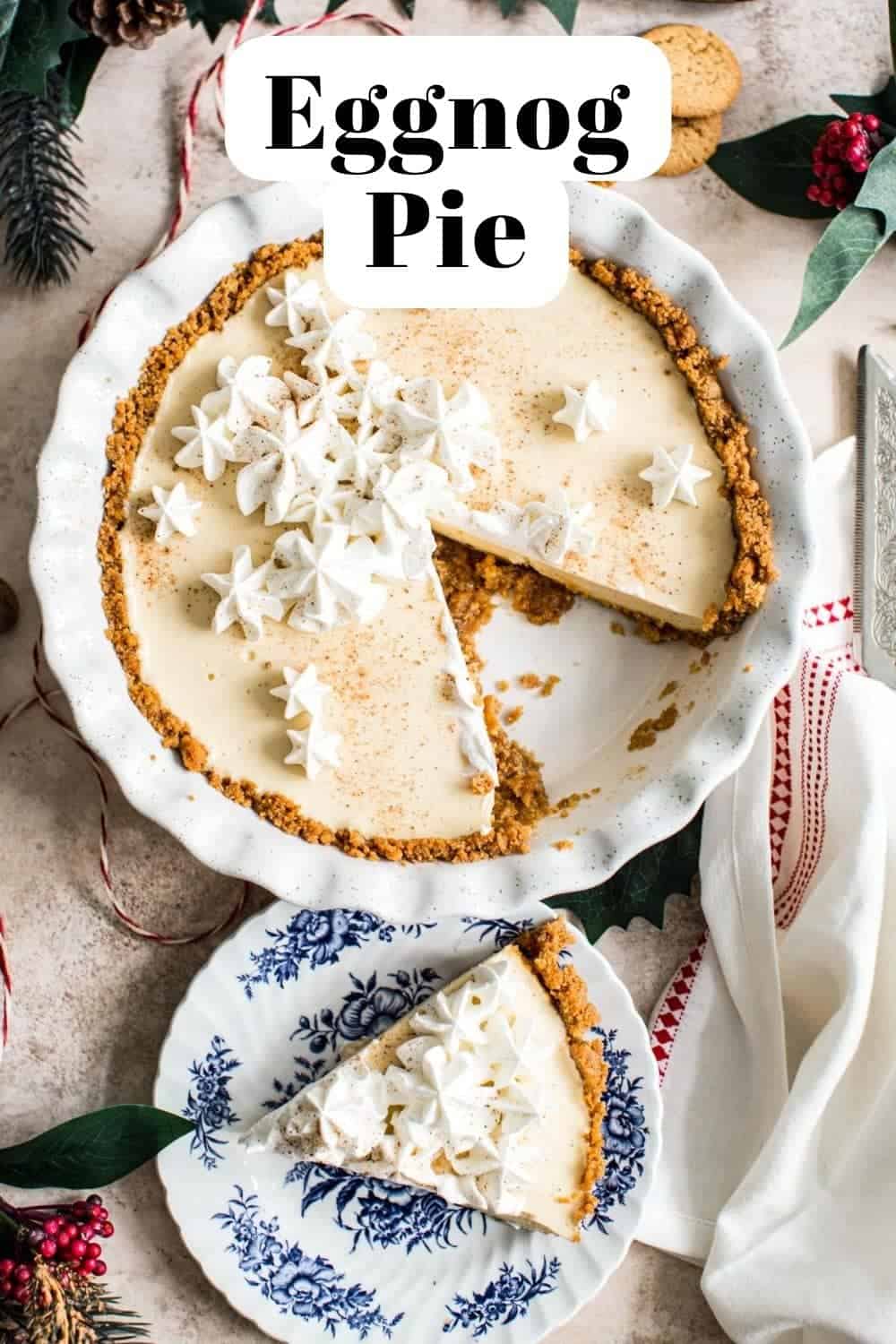 Eggnog cream pie with a slice cut out sitting on a blue and white plate.