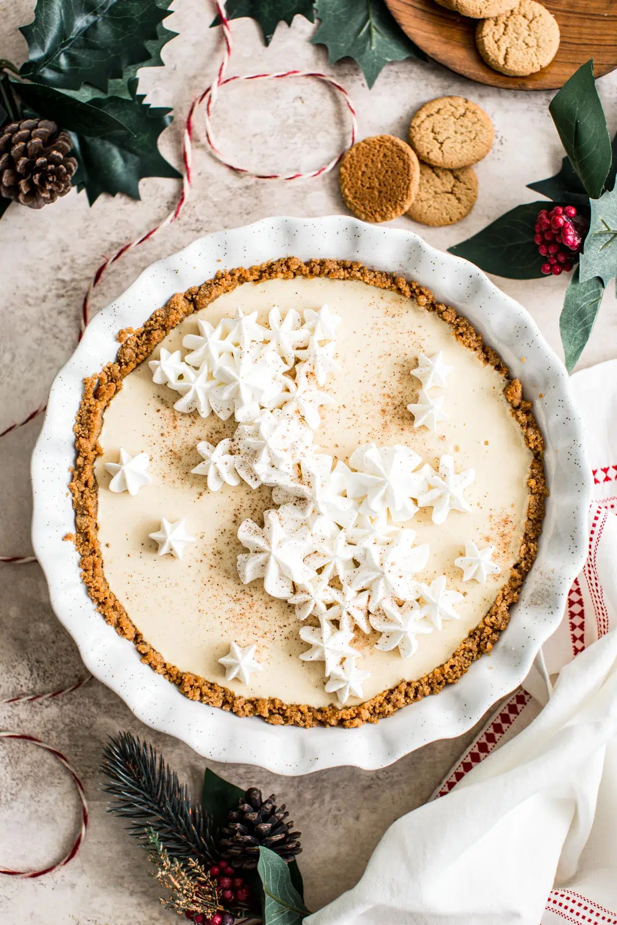 Eggnog custard pie topped with whipped cream and nutmeg.