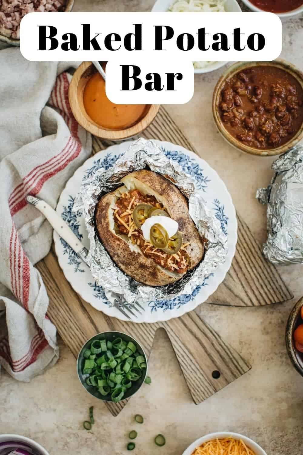 Loaded potato bar with a potato on a plate in the center.