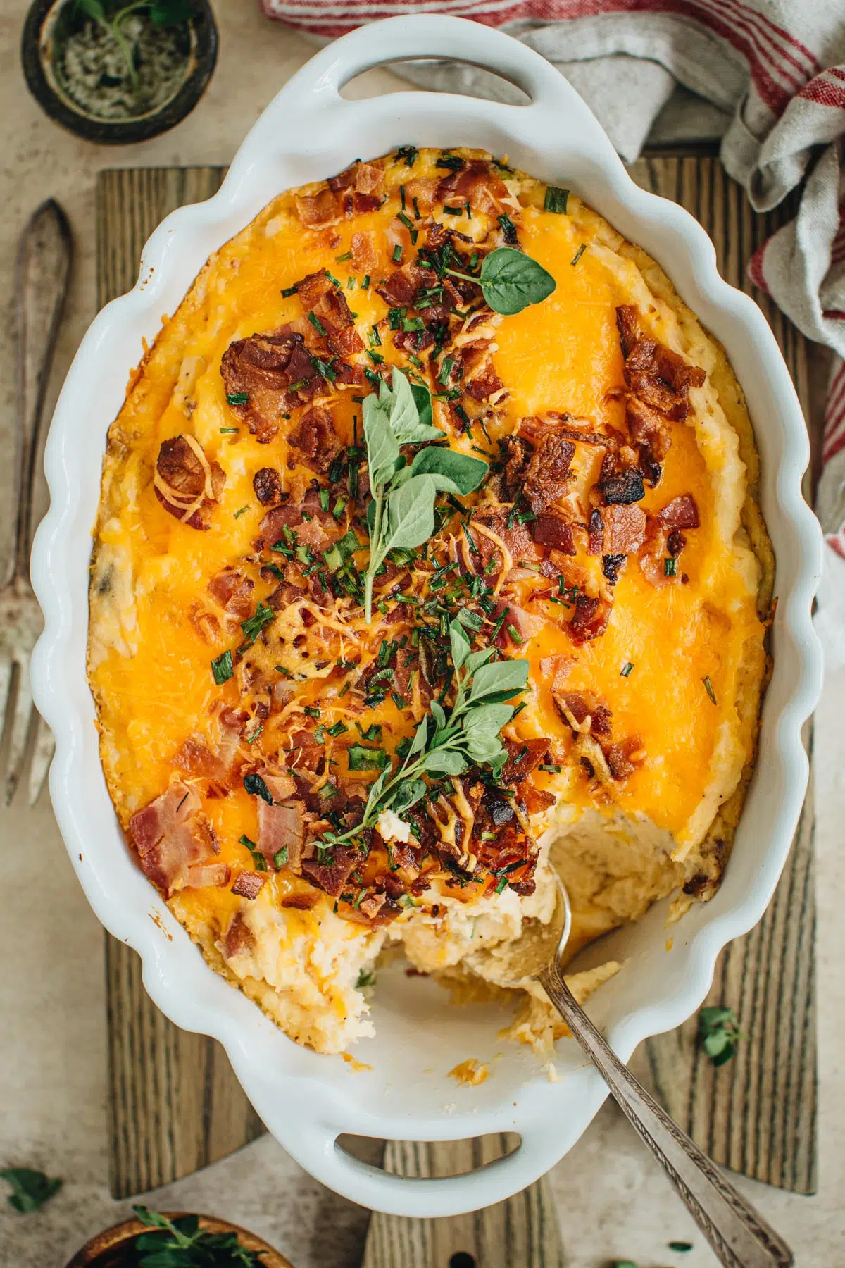 Loaded potato casserole in a white casserole dish.