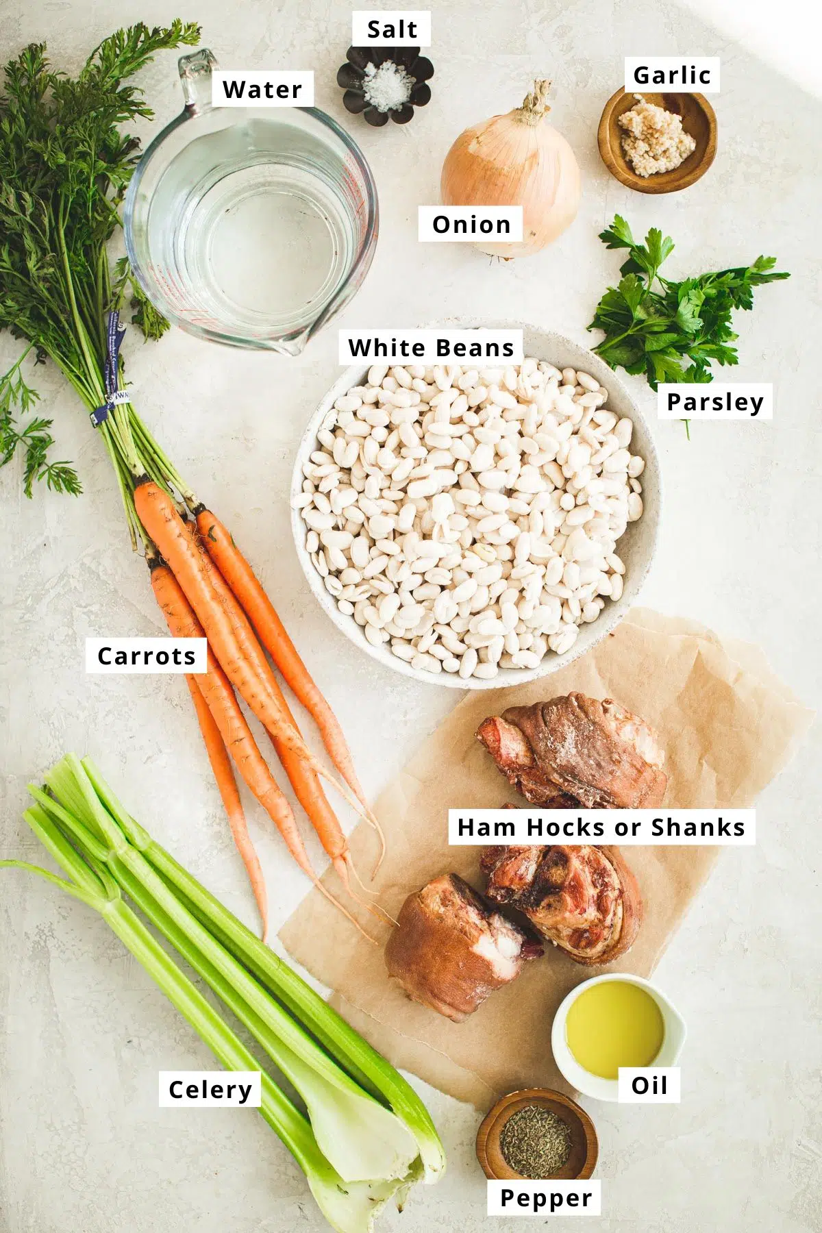 White bean ham hock soup ingredients in various bowls.