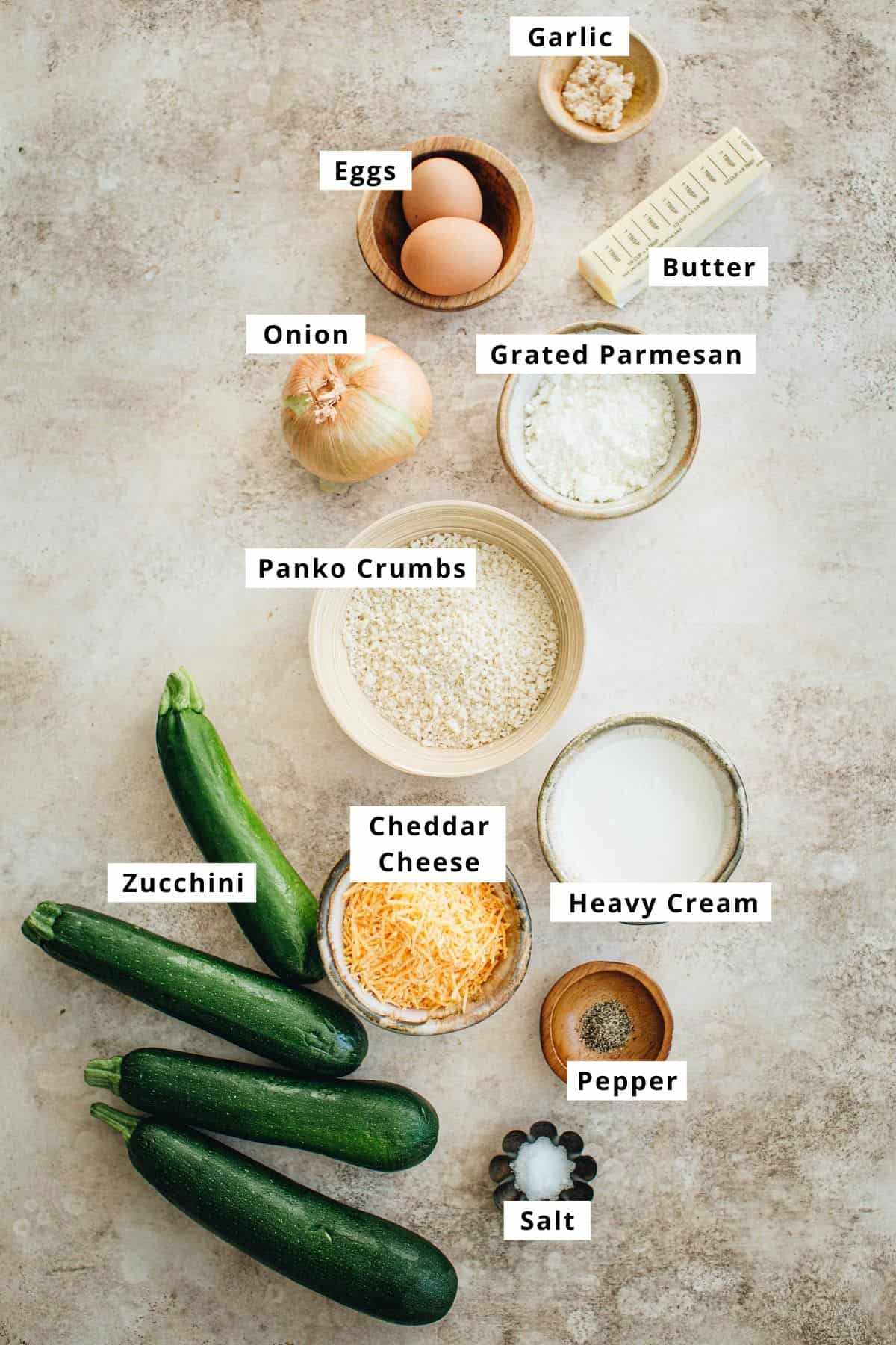Zucchini casserole recipe ingredients in various bowls.