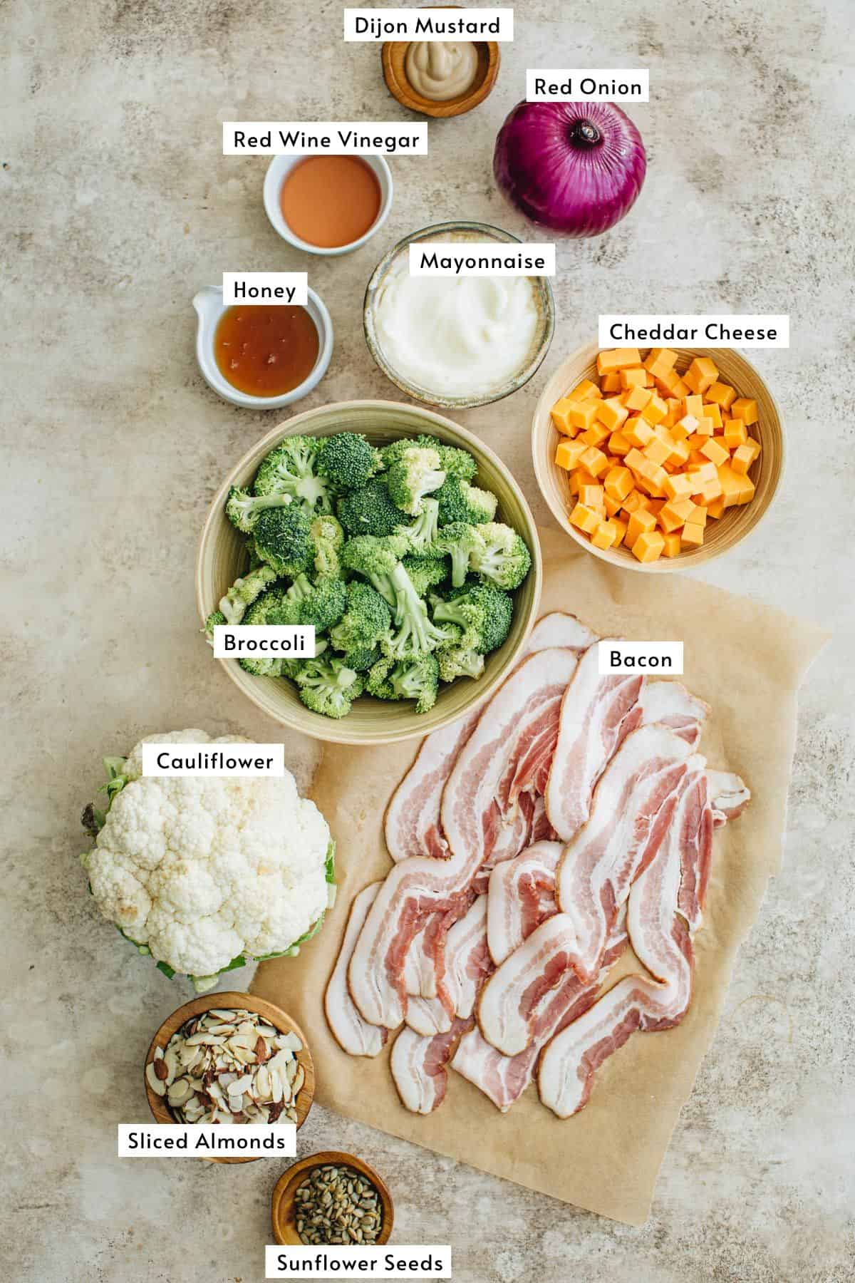 Broccoli cauliflower salad ingredients in various bowls.