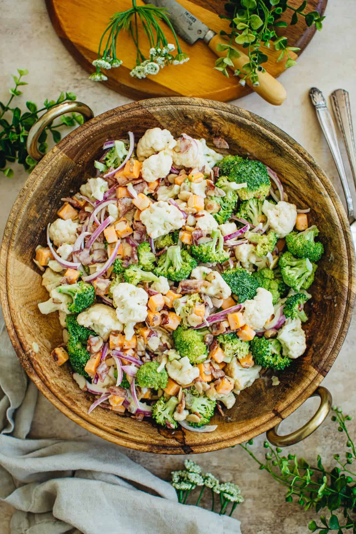 Broccoli and cauliflower salad in a wooden bowl.