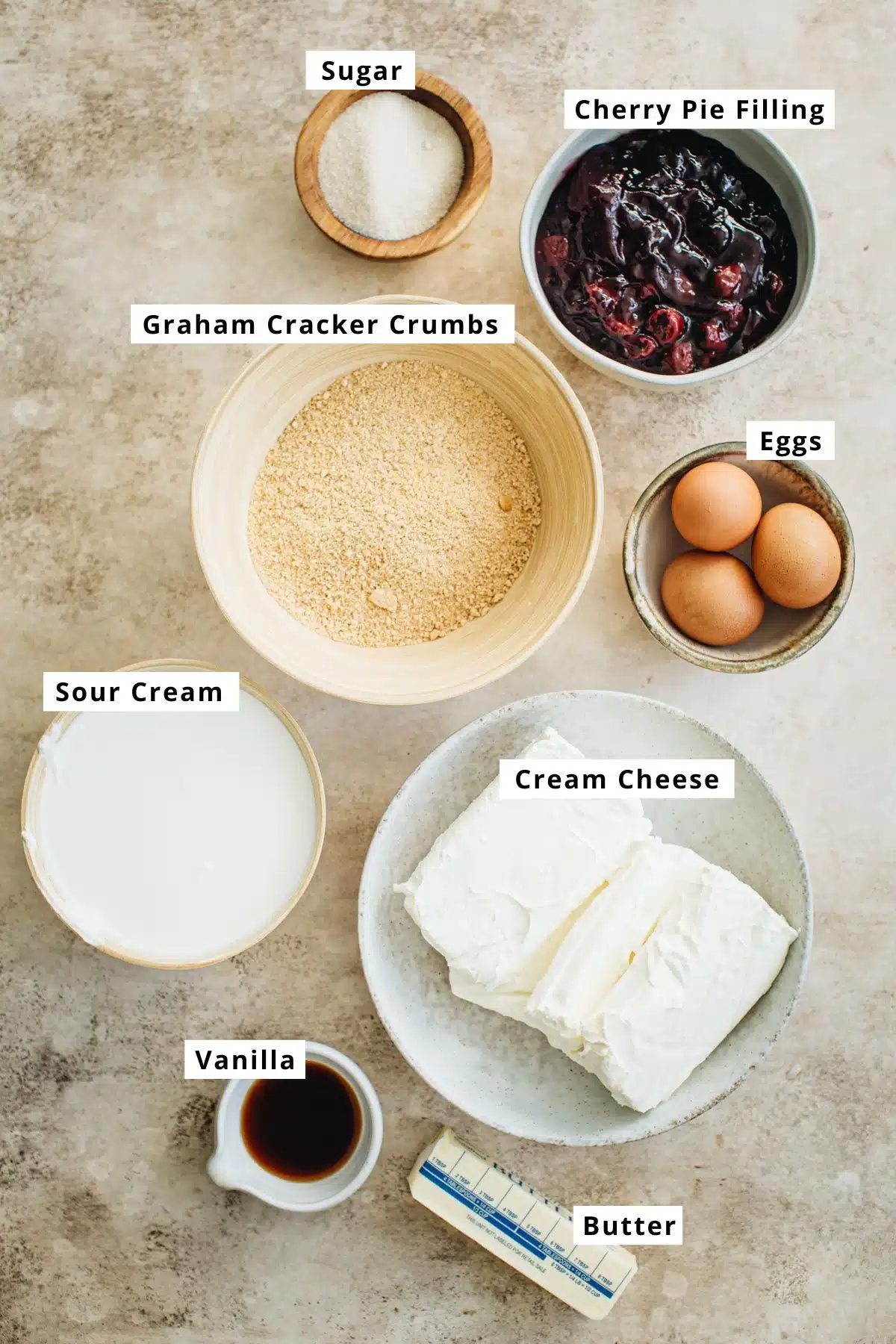 Cherry cheesecake recipe ingredients in various bowls.