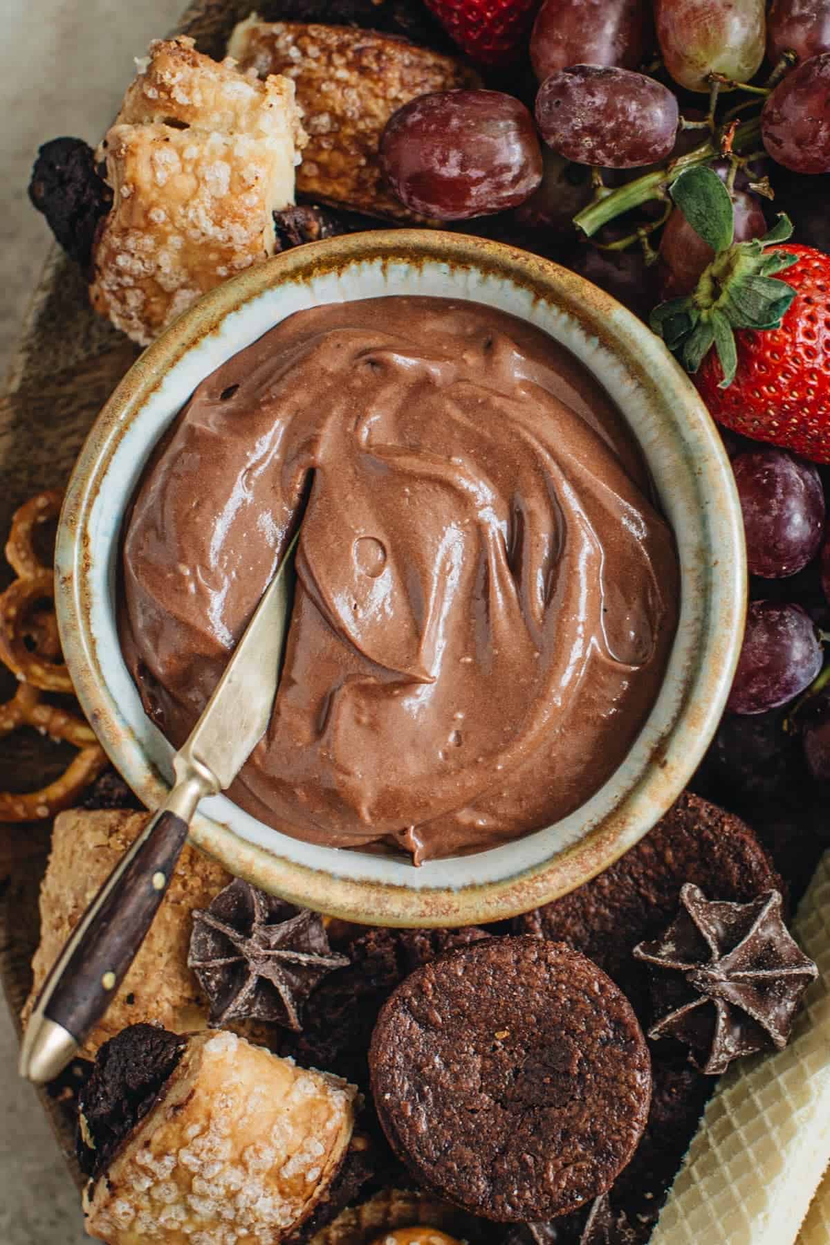 Dessert board dip in a bowl.