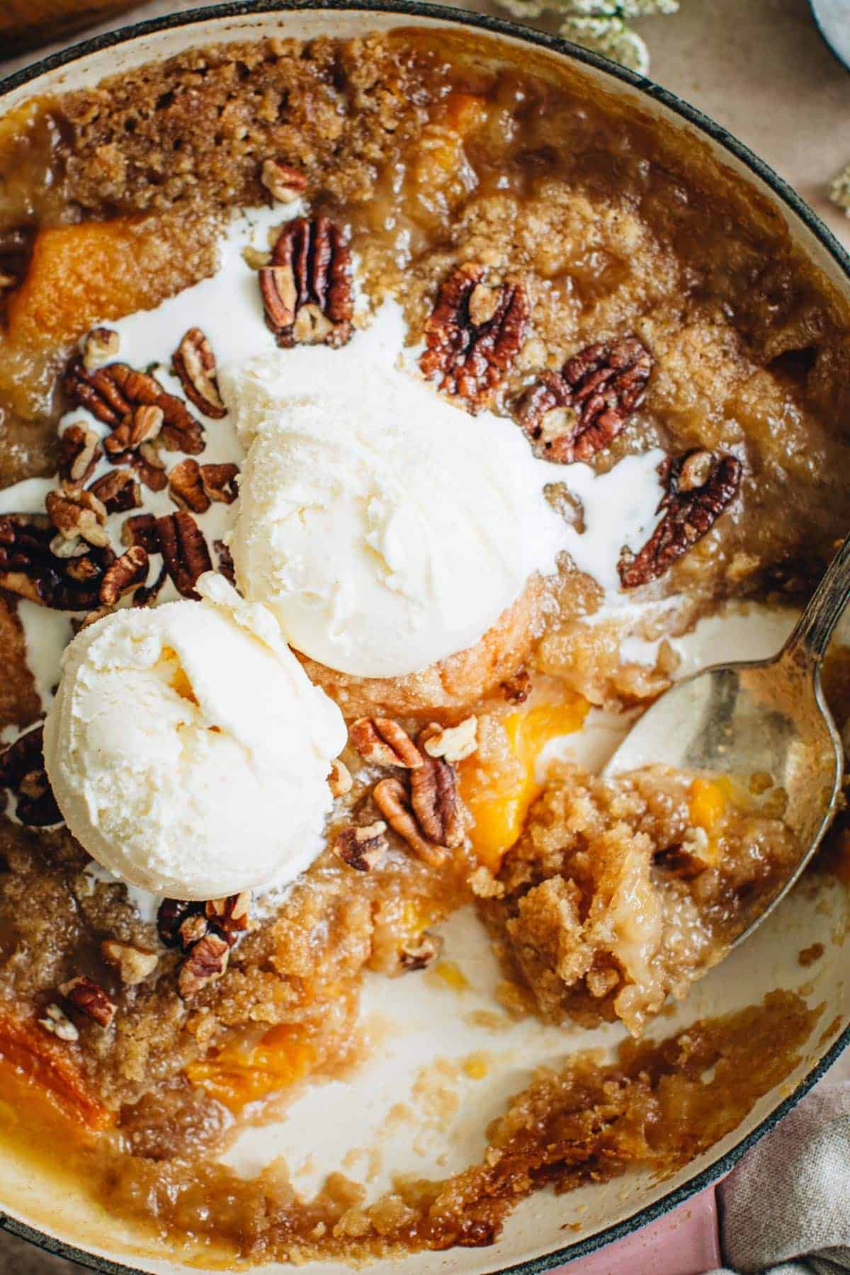 Easy peach crumble topped with vanilla ice cream.