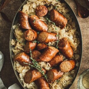 Kielbasa and sauerkraut in an oven baking pot.