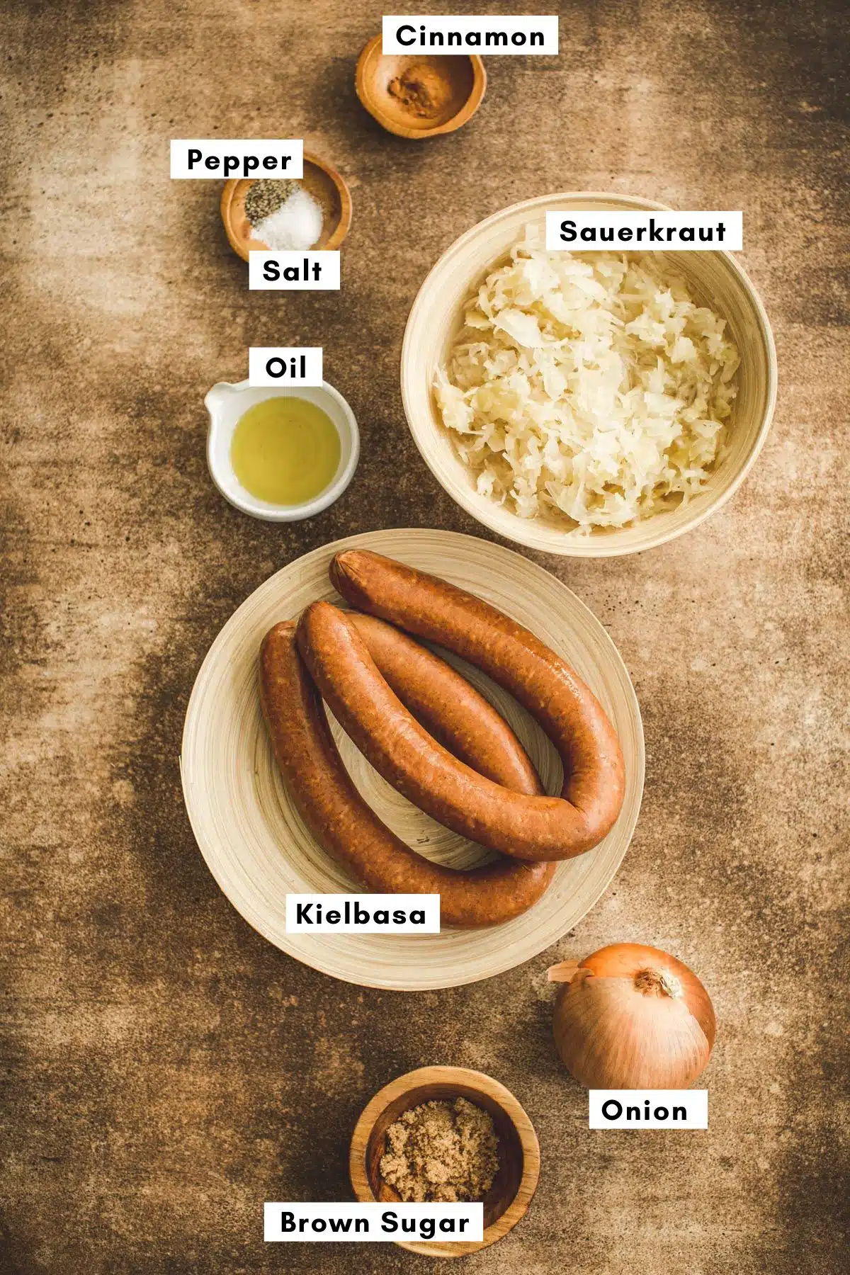 Kielbasa and sauerkraut recipe ingredients in various bowls.
