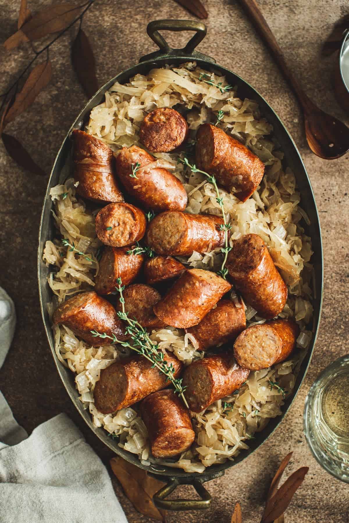 Kielbasa and sauerkraut in an oven baking pot.