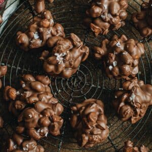 Peanut clusters on a round wire baking rack.
