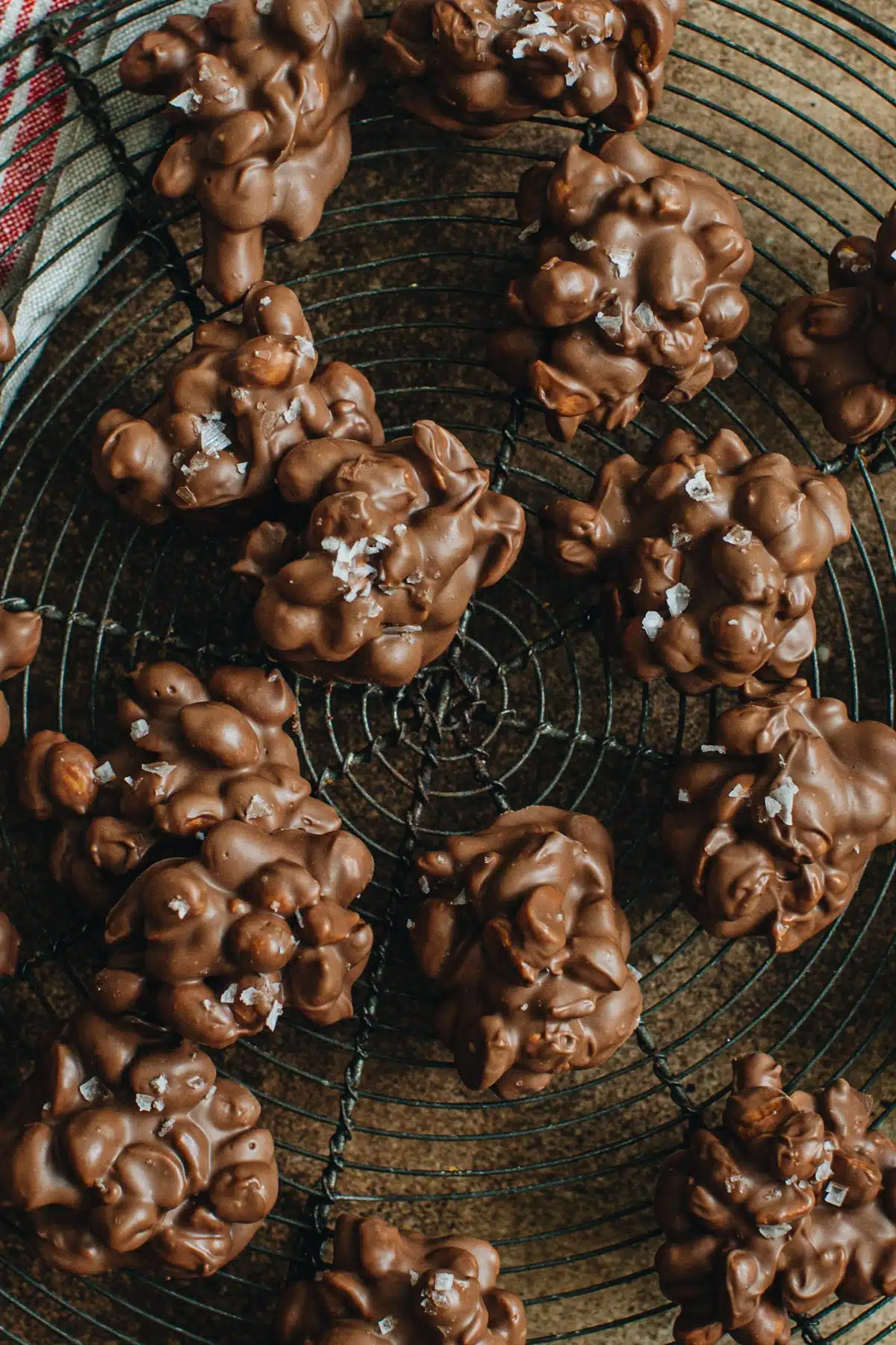 Peanut clusters on a round wire baking rack.