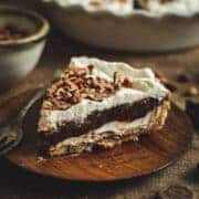 Possum pie slice on a wooden plate.