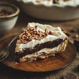 Possum pie slice on a wooden plate.