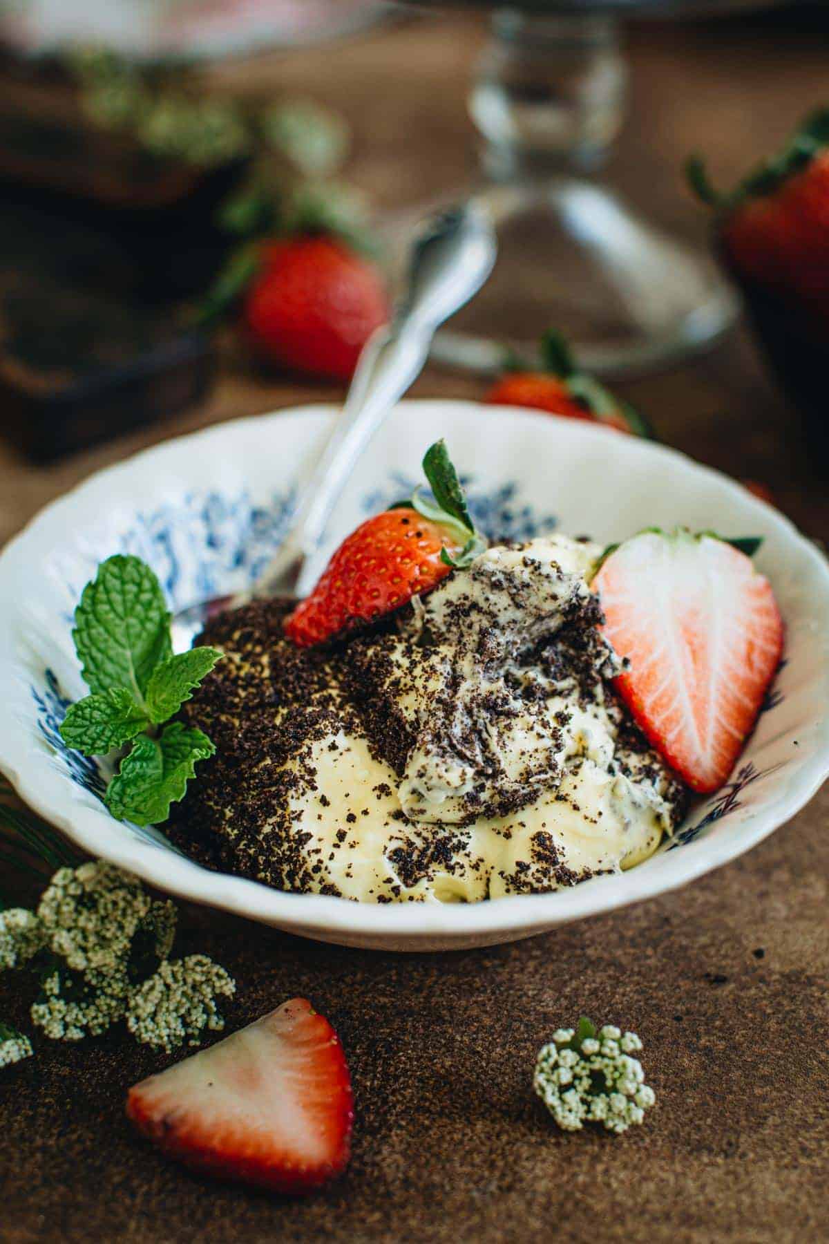 Oreo dirt pudding with fresh strawberries in a bowl.