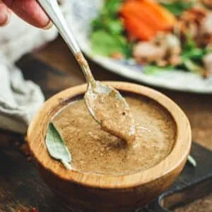 Hot bacon dressing in a wooden bowl.