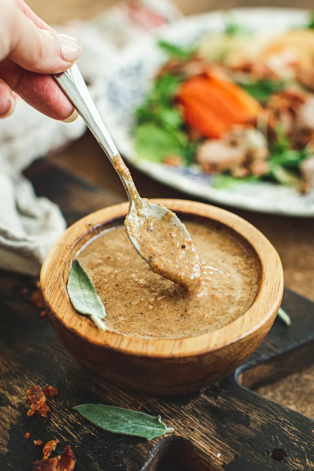 Hot bacon dressing in a wooden bowl.