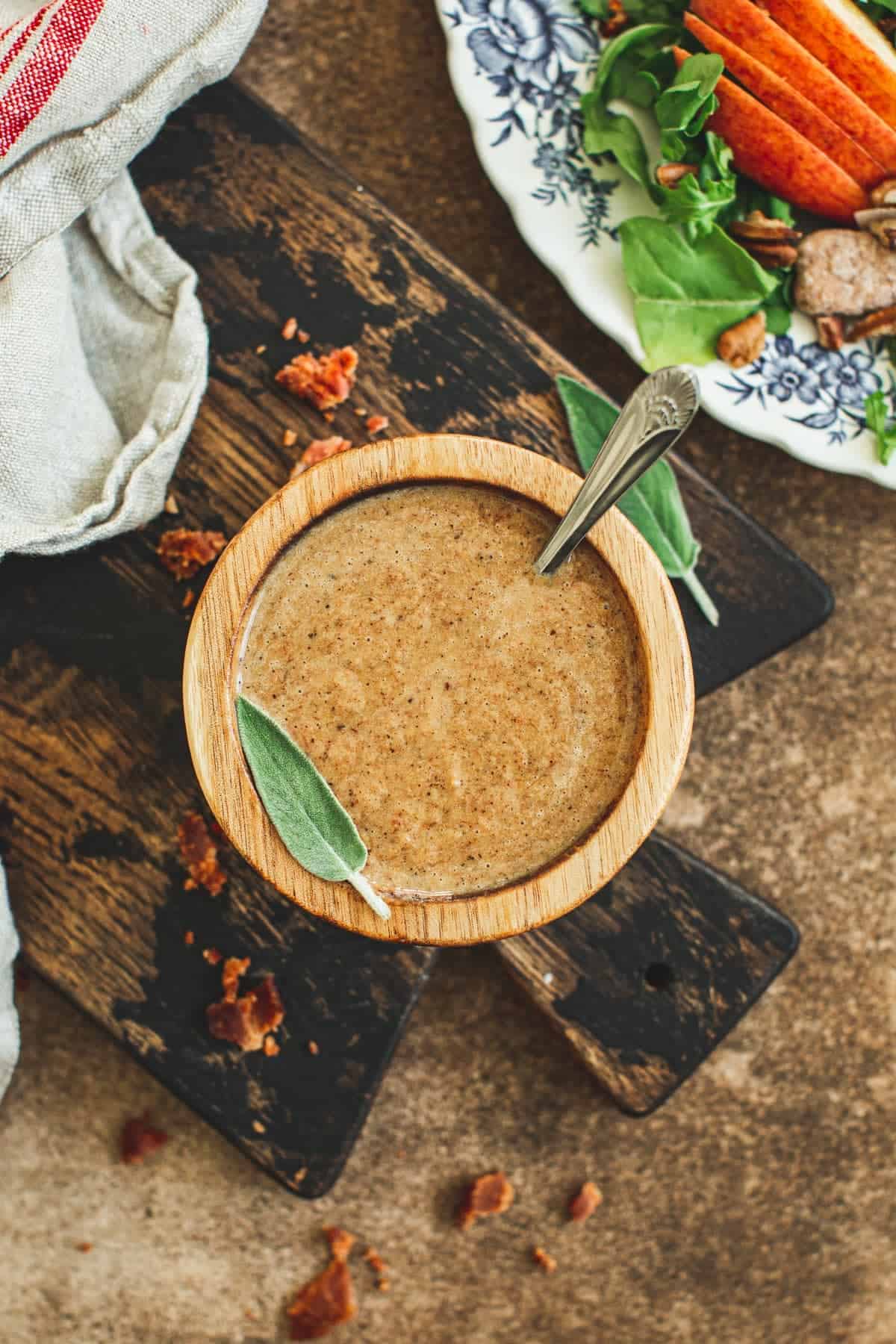 Hot bacon salad dressing in a wooden bowl.
