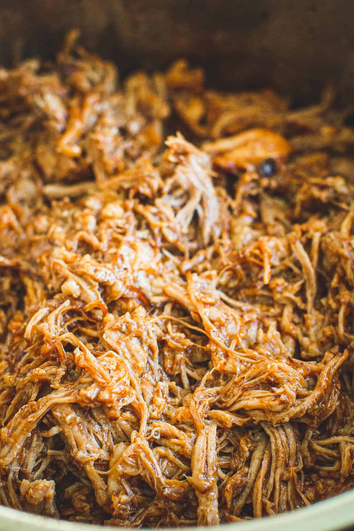 Pulled pork slathered in bbq sauce.