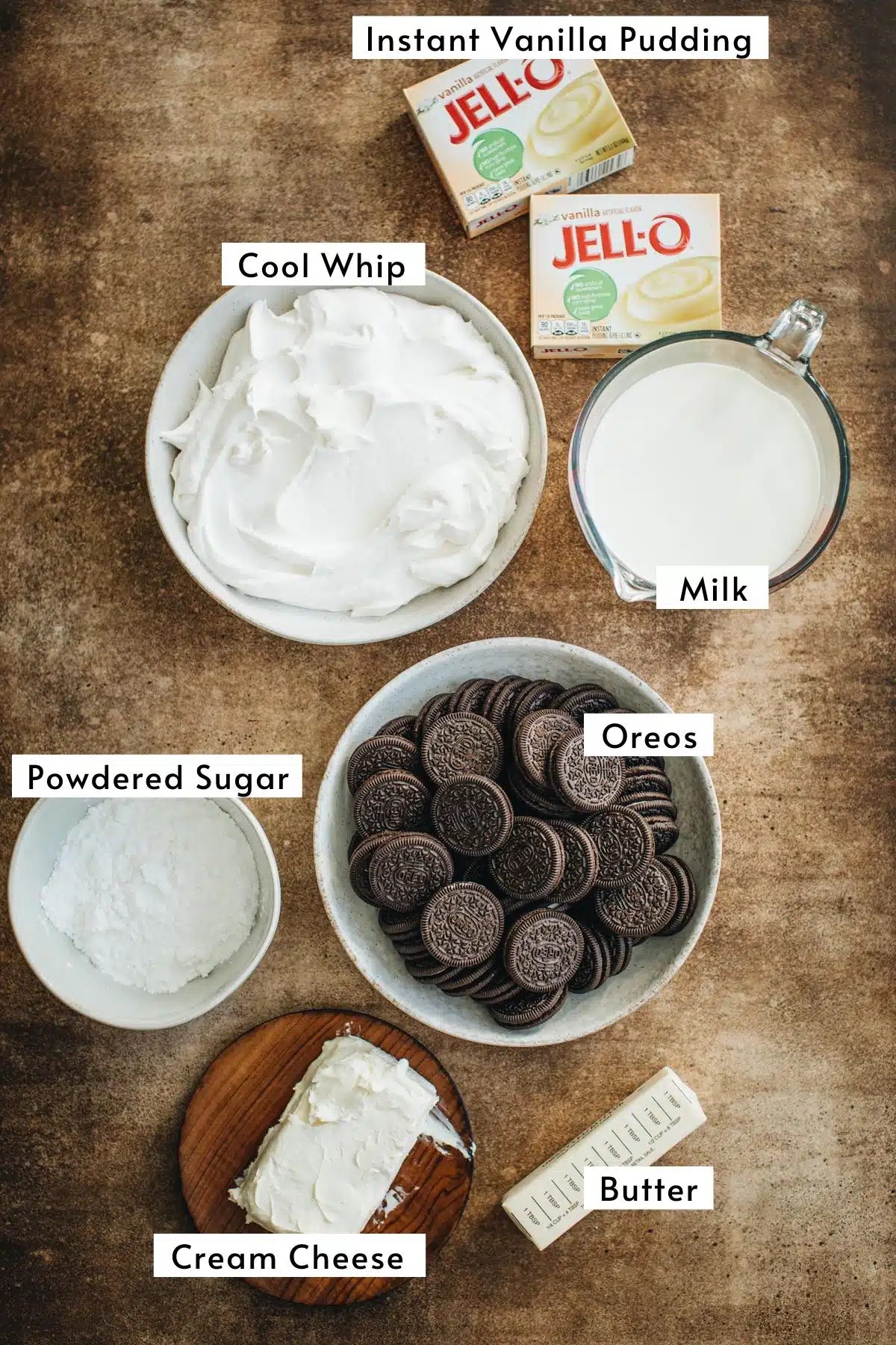 Oreo dirt cake recipe ingredients in various bowls.