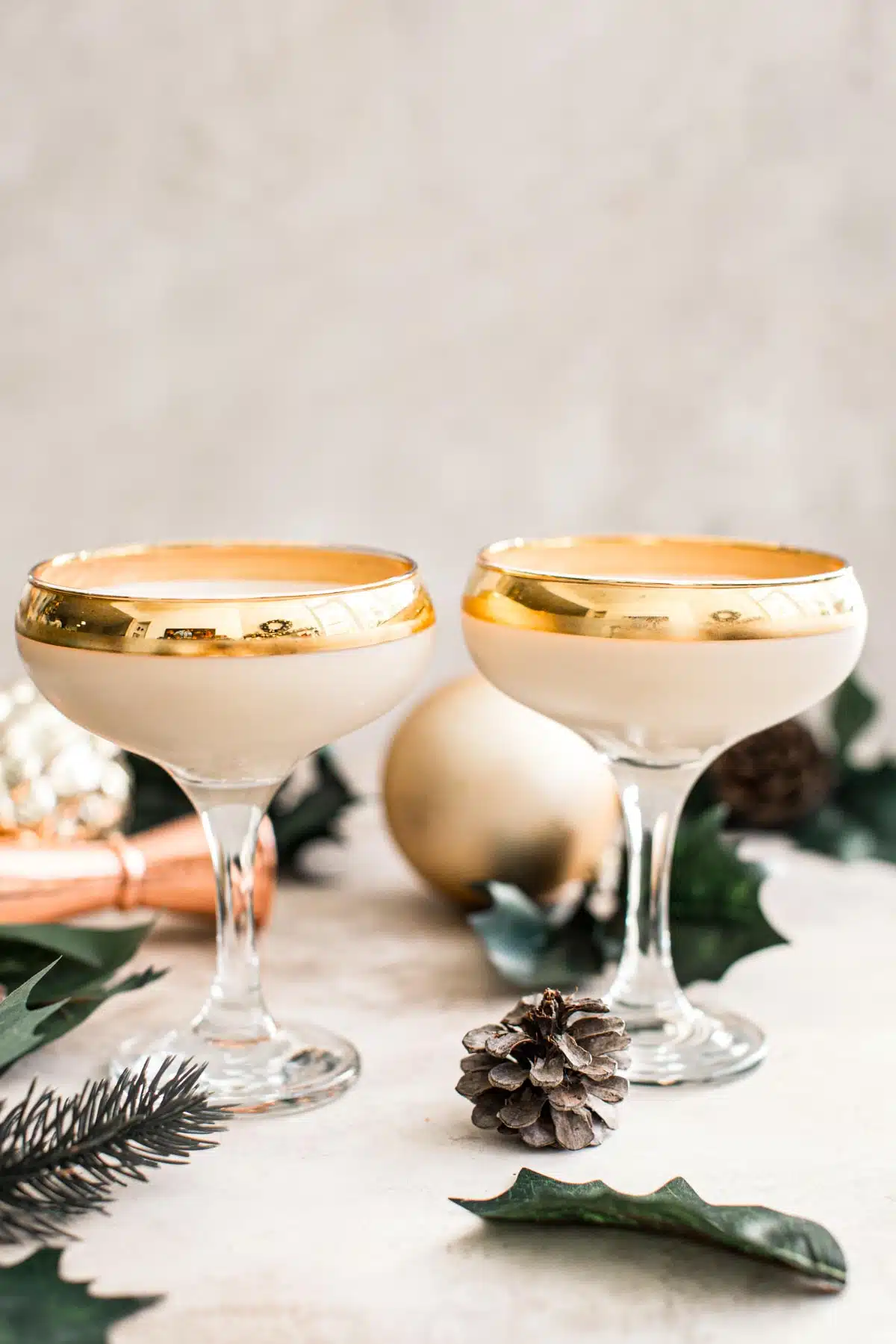 Two toasted almond martini glasses with gold rims.