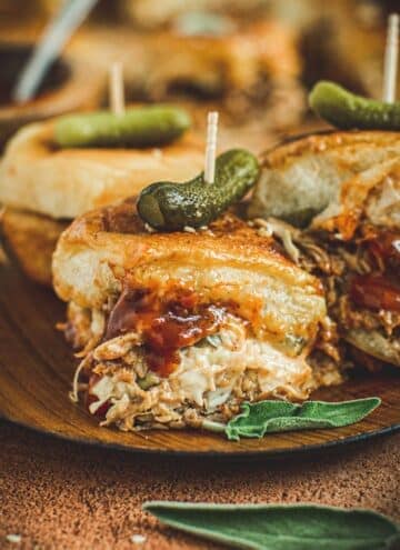 BBQ pulled pork slider on a wooden plate.