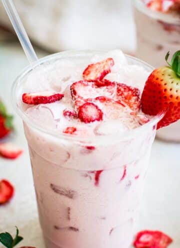 Starbucks pink drink topped with freeze-dried strawberries.