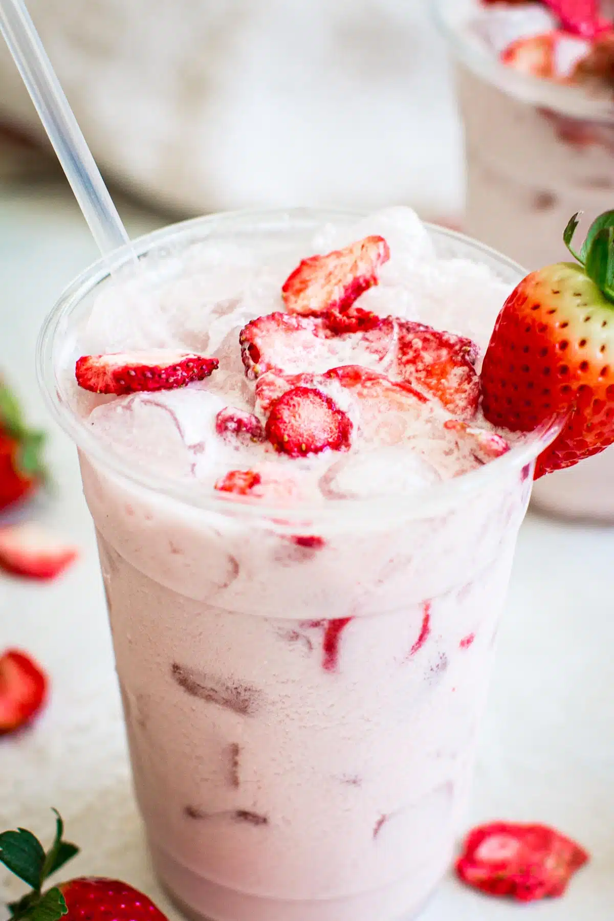 Starbucks pink drink topped with freeze-dried strawberries.