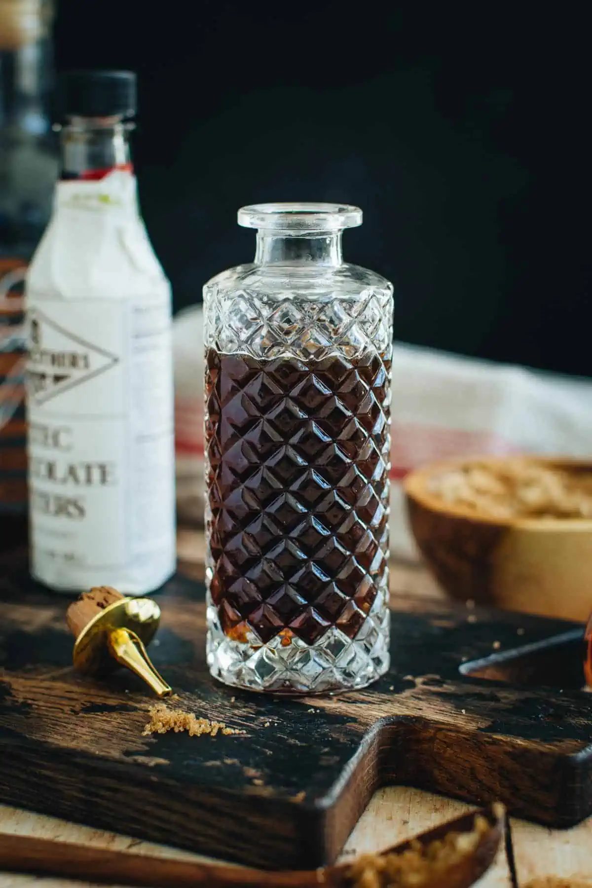 Brown sugar simple syrup in a faceted bottle.