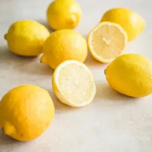 Lots of lemons with one cut in half.