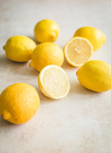 Lots of lemons with one cut in half.