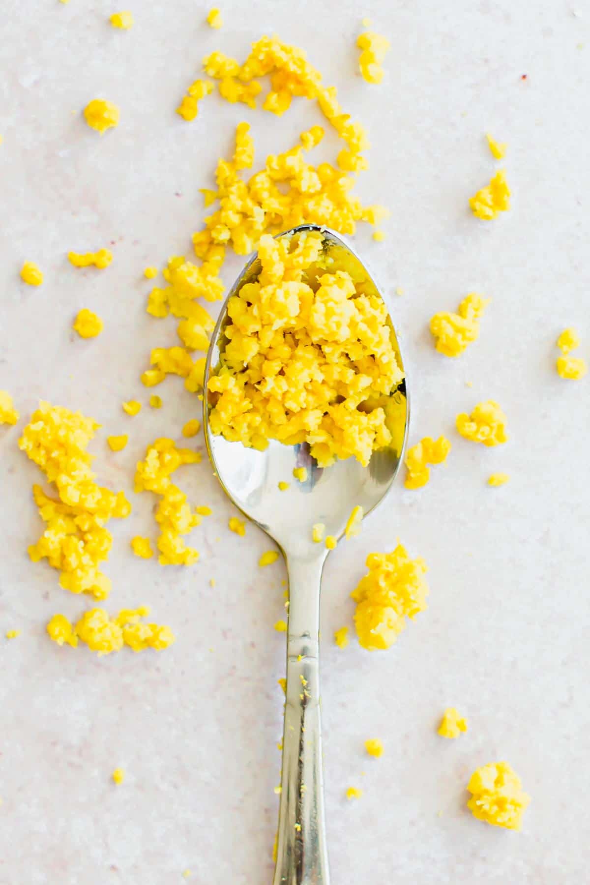 Lemon zest on a silver spoon.