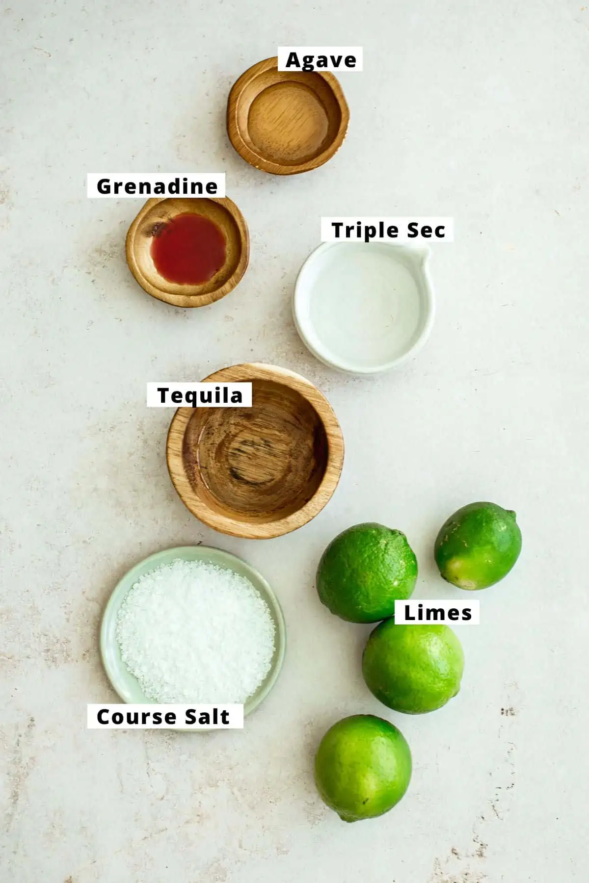 Pink margarita ingredients in various bowls.