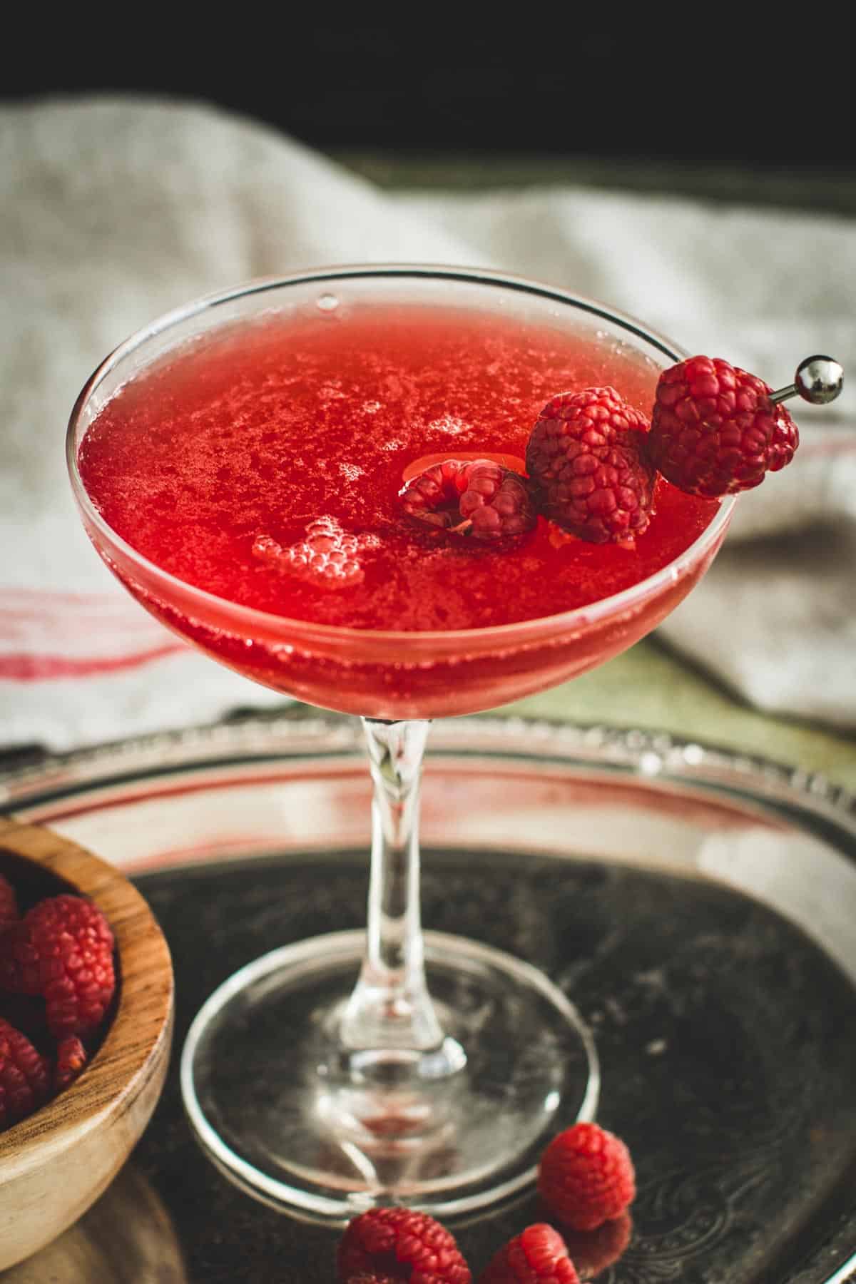 Raspberry martini garnished with fresh raspberries.