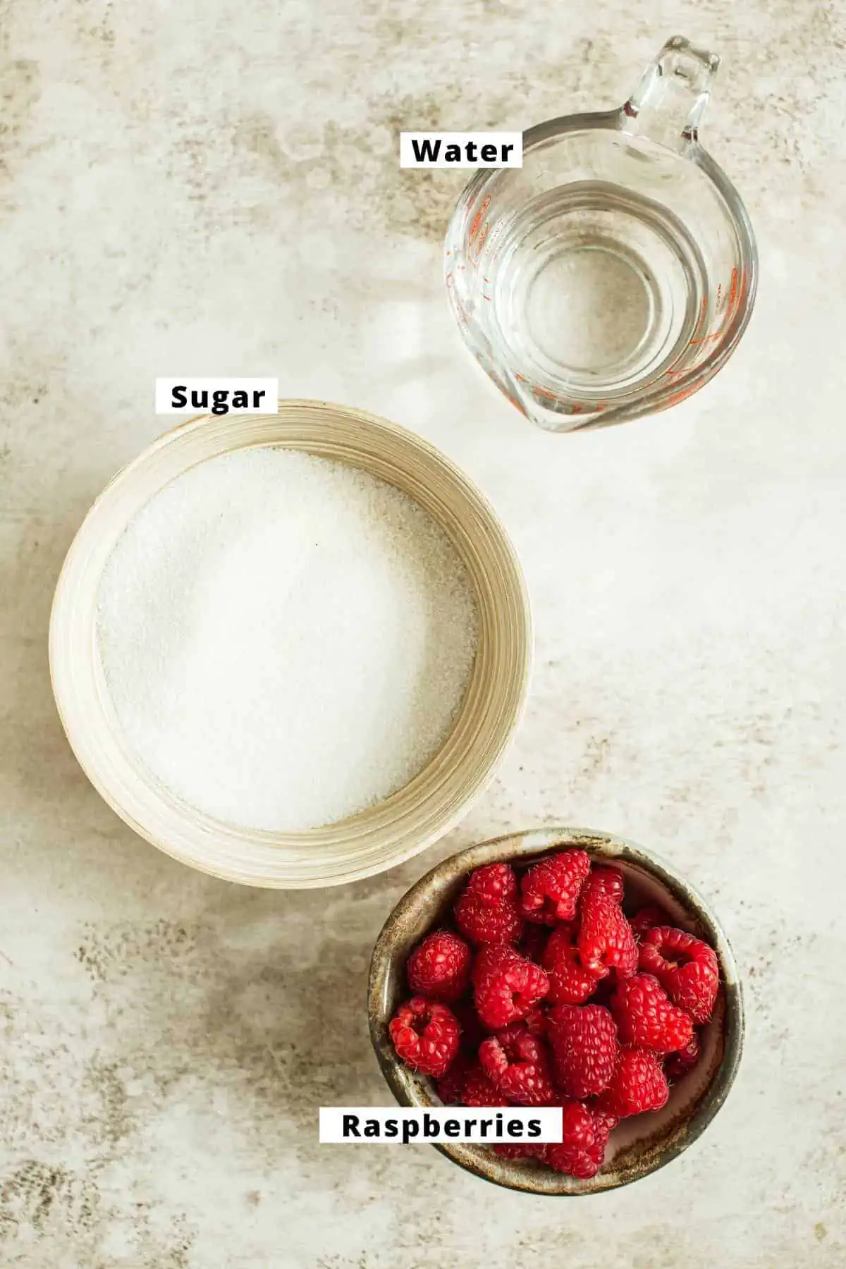 Raspberry simple syrup ingredients in various bowls.